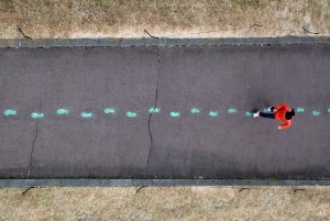 image showing person walking in pre-painted footprints